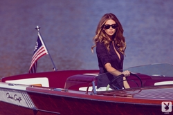 Maggie May driving a boat for Playboy Plus
