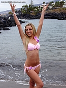 Girl with her Arms in the Air on the Beach