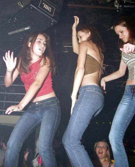 Three Cute Girls in Jeans Dancing on Stage