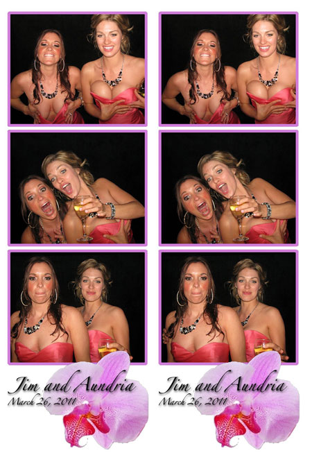 Two girls putting their hands on their boobs in a wedding photobooth