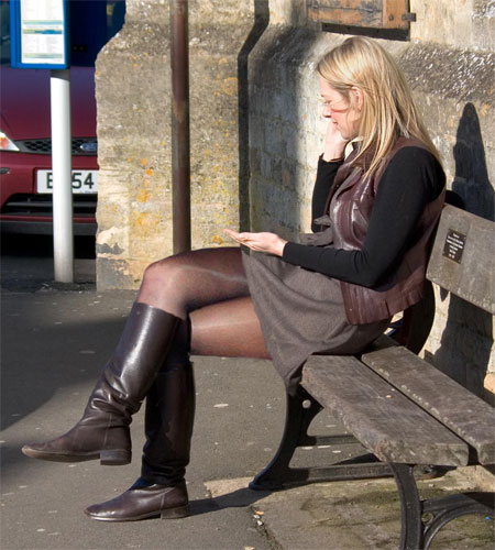 Candid Blonde in Pantyhose and Boots on a Bench