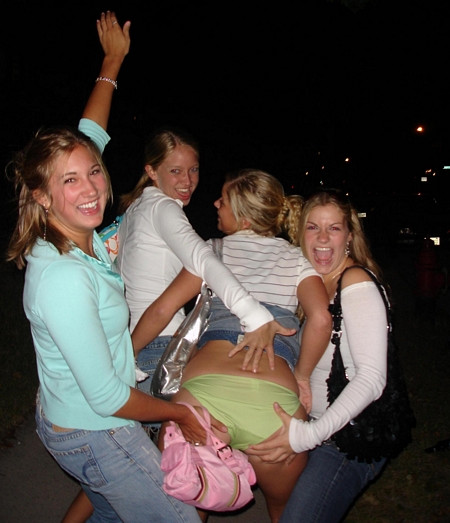 Girl has her skirt lifted up by her buddies