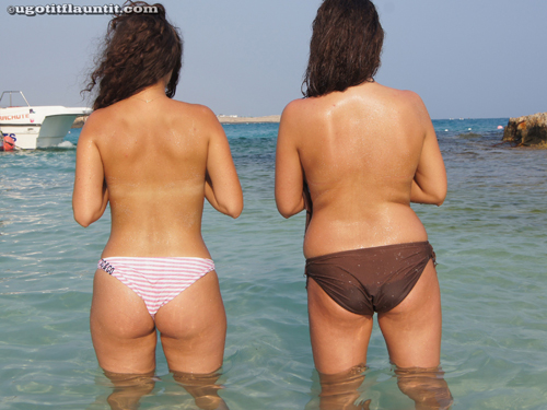 Two girls get topless on the beach
