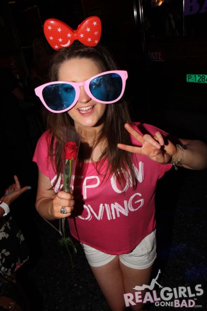 Party girl in sunglasses shows off