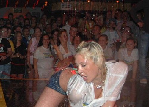 Drunk party girl shows off on stage in a Magaluf club