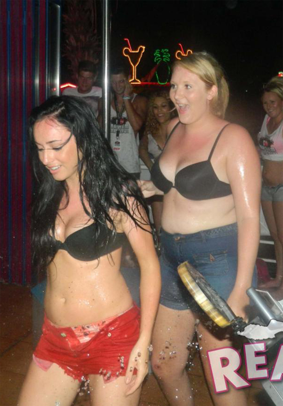Two party girls start to strip off ready for a competition