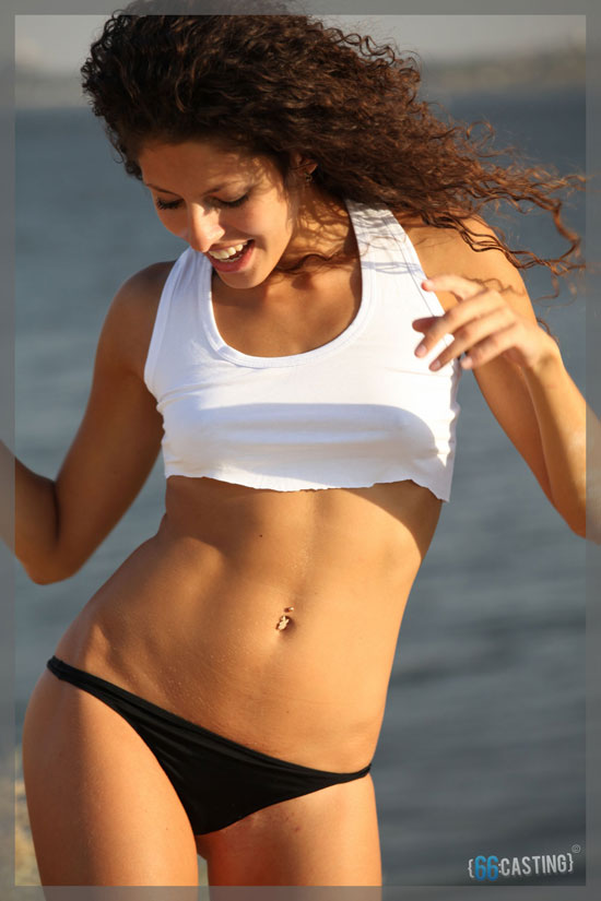 Fit girl posing for the first time on the beach