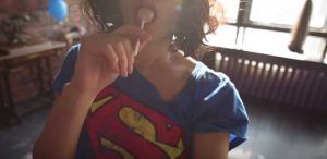 ShpitsyQ in a supergirl shirt sucking a lolly on StasyQ