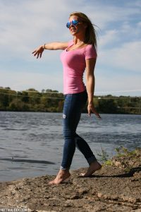 Sexy Meet Madden standing outdoors in her pink top and tight jeans