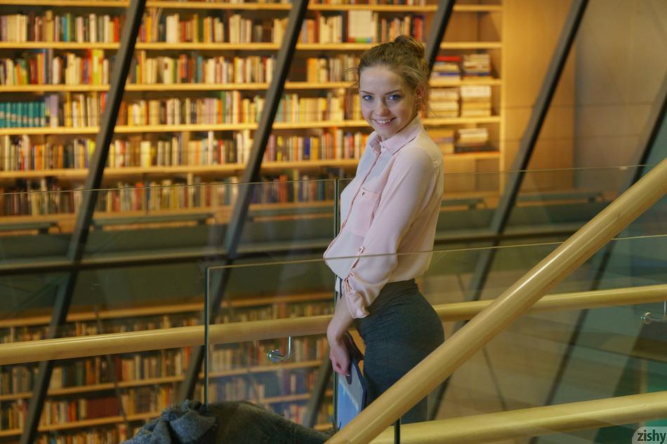 Cute librarian Faina Bona standing in her library for Zishy
