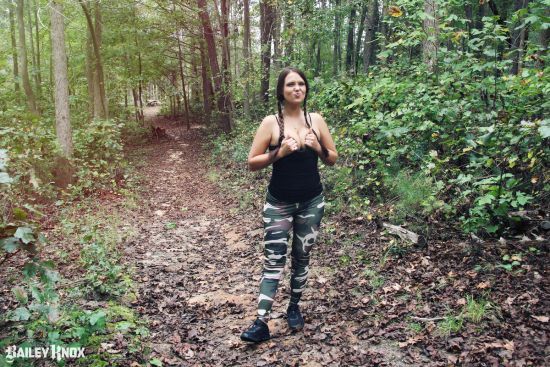 Sexy Bailey Knox squeezing her boobs together in the woods