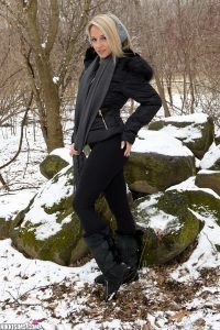 Nikki Sims posing outdoors in the snow in black leggings