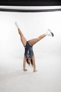 Swimsuit coed spreads her legs