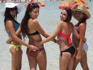 Bikini girls pose on the beach