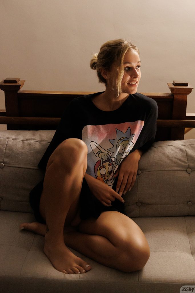 Blonde girl in her night shirt on the sofa